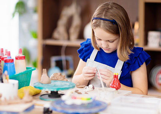 woman painting pottery
